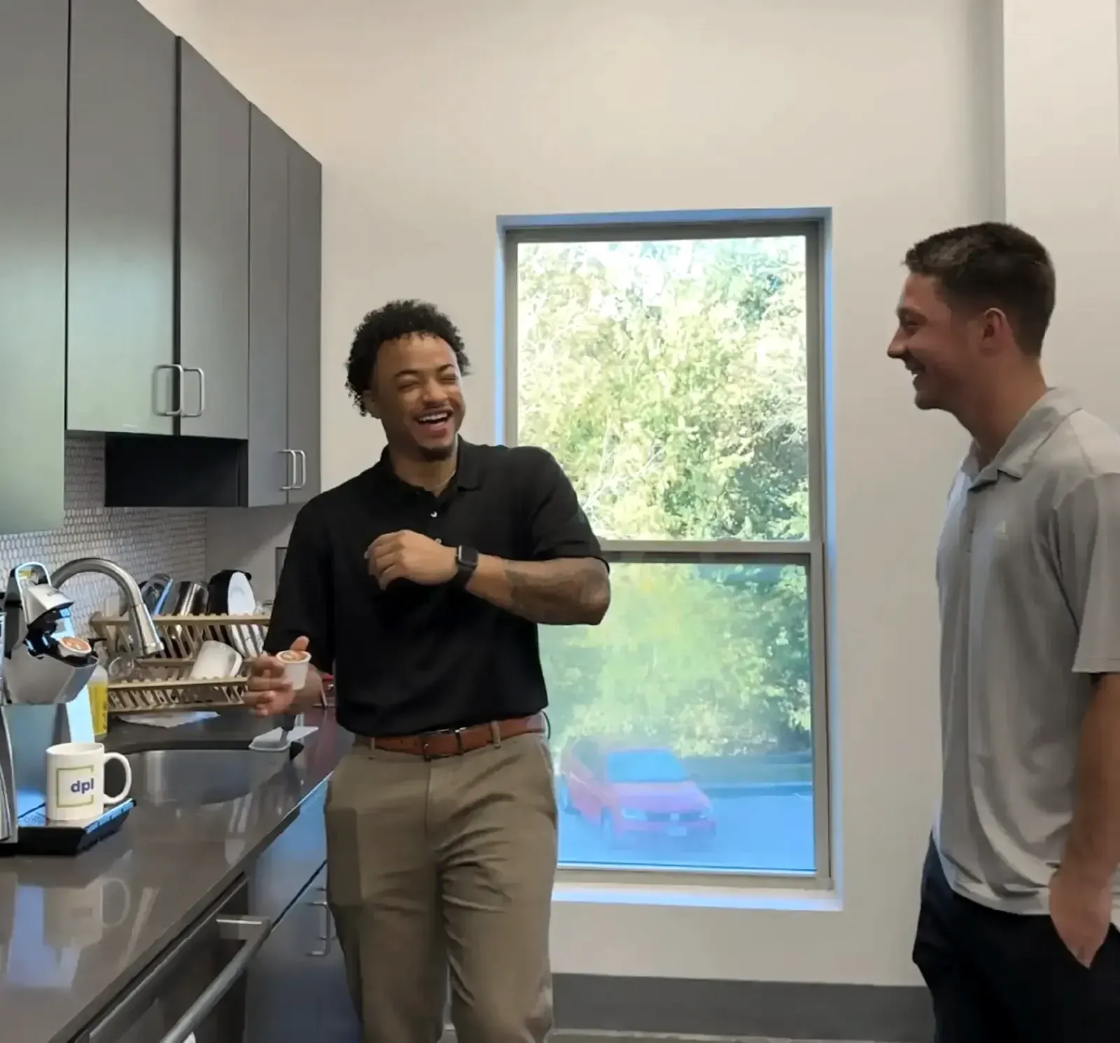 Two colleagues talking in DPL’s office break room