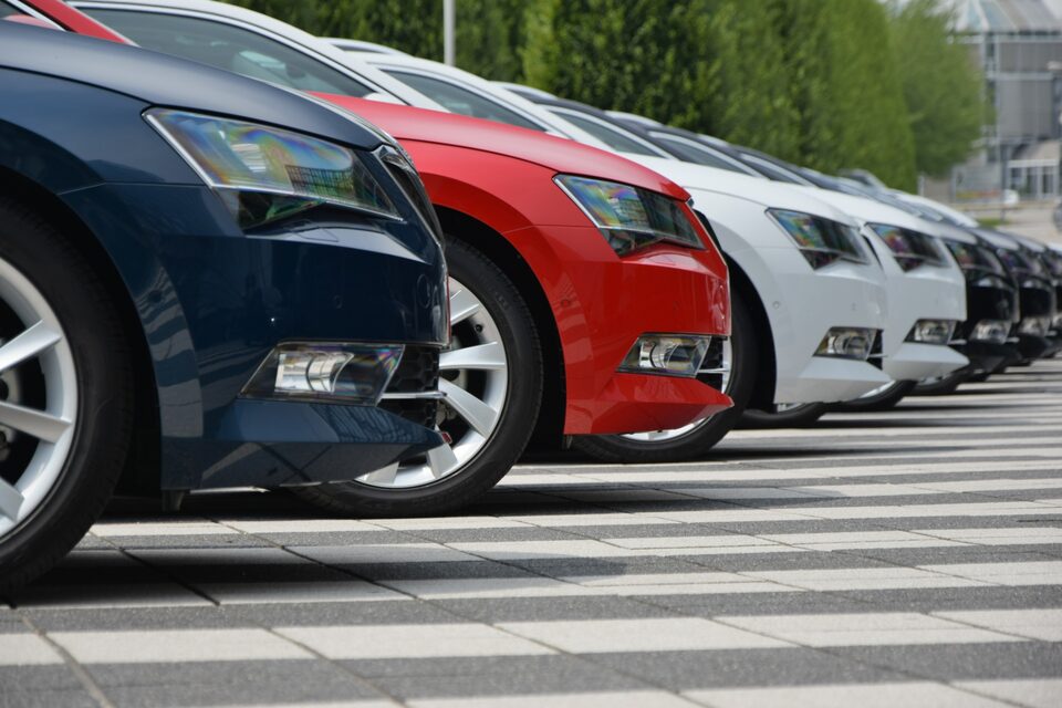 A row of parked vehicles illustrating fleet inventory awaiting movement