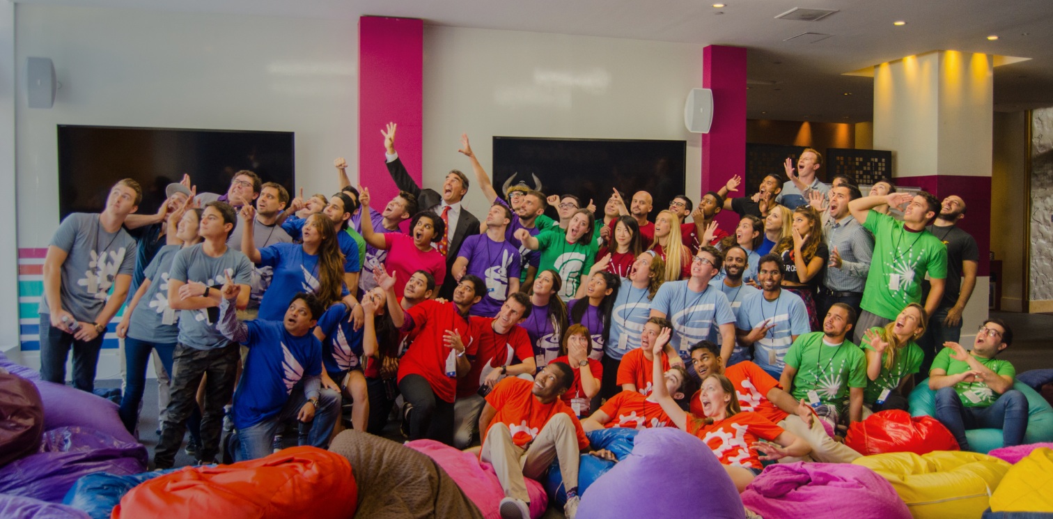 Draper University participants and Tim Draper gathered among colorful beanbag chairs
