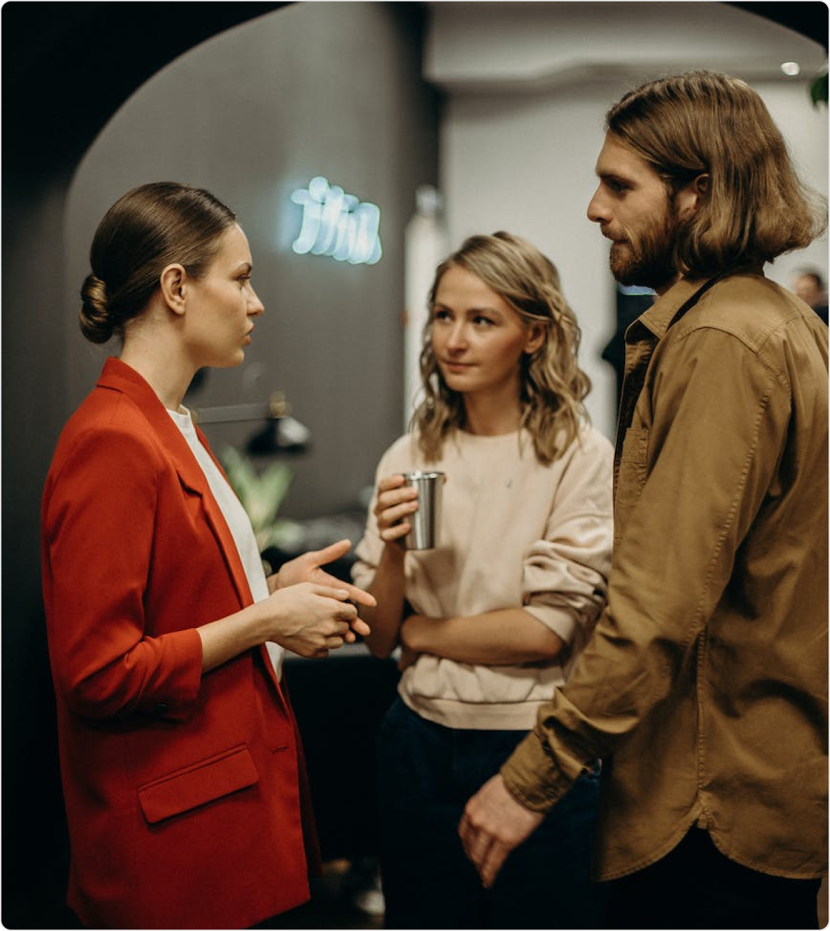 Three people in conversation in a photograph published by Pivotal Product School