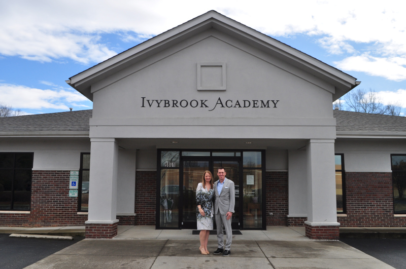 Jennifer and Drew McWilliams standing outside the original Ivybrook Academy campus