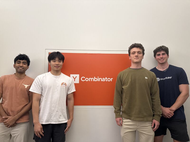 The four Revere founders standing in front of a Y Combinator sign