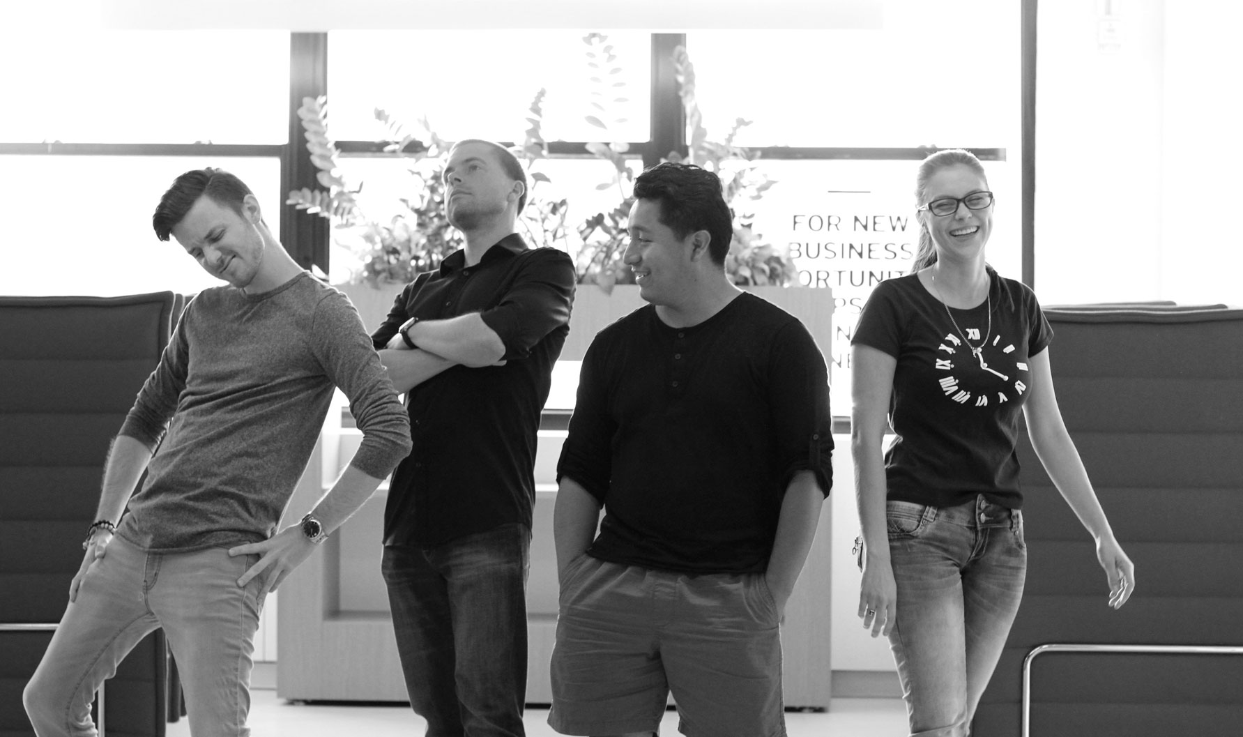 Four members of the early Sally team in a black-and-white office photograph