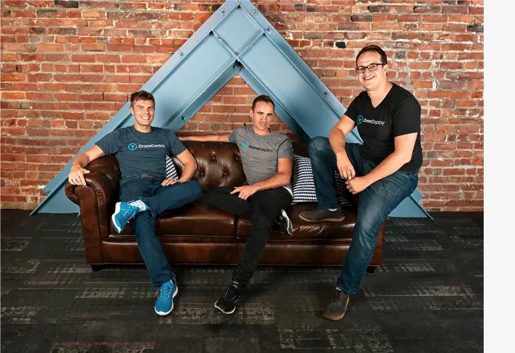 DroneDeploy’s three co-founders sitting together on and beside a leather sofa