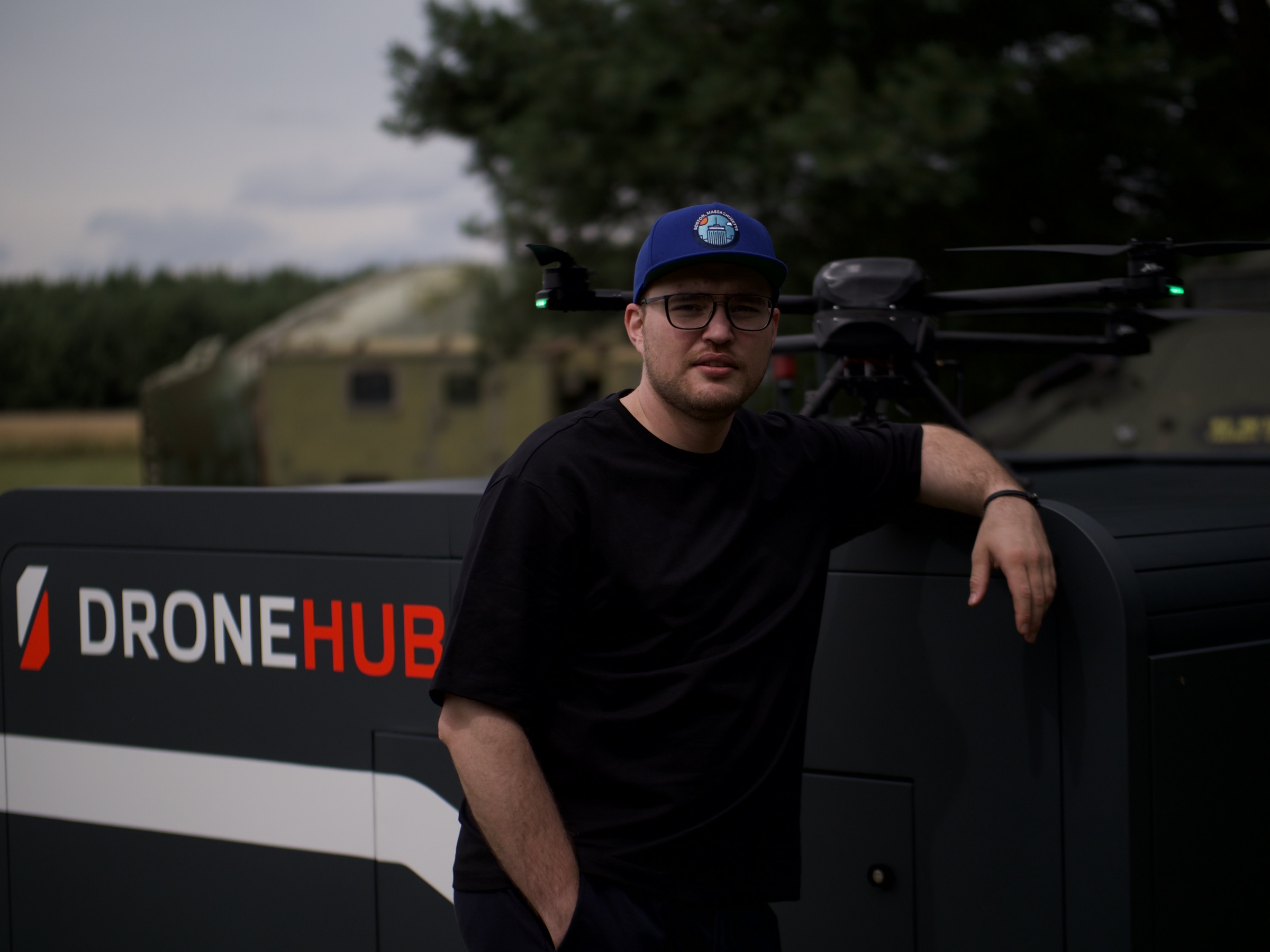 Dronehub founder Vadym Melnyk standing beside company hardware