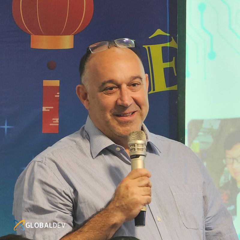 Dror Har holding a microphone during his Vietnam visit