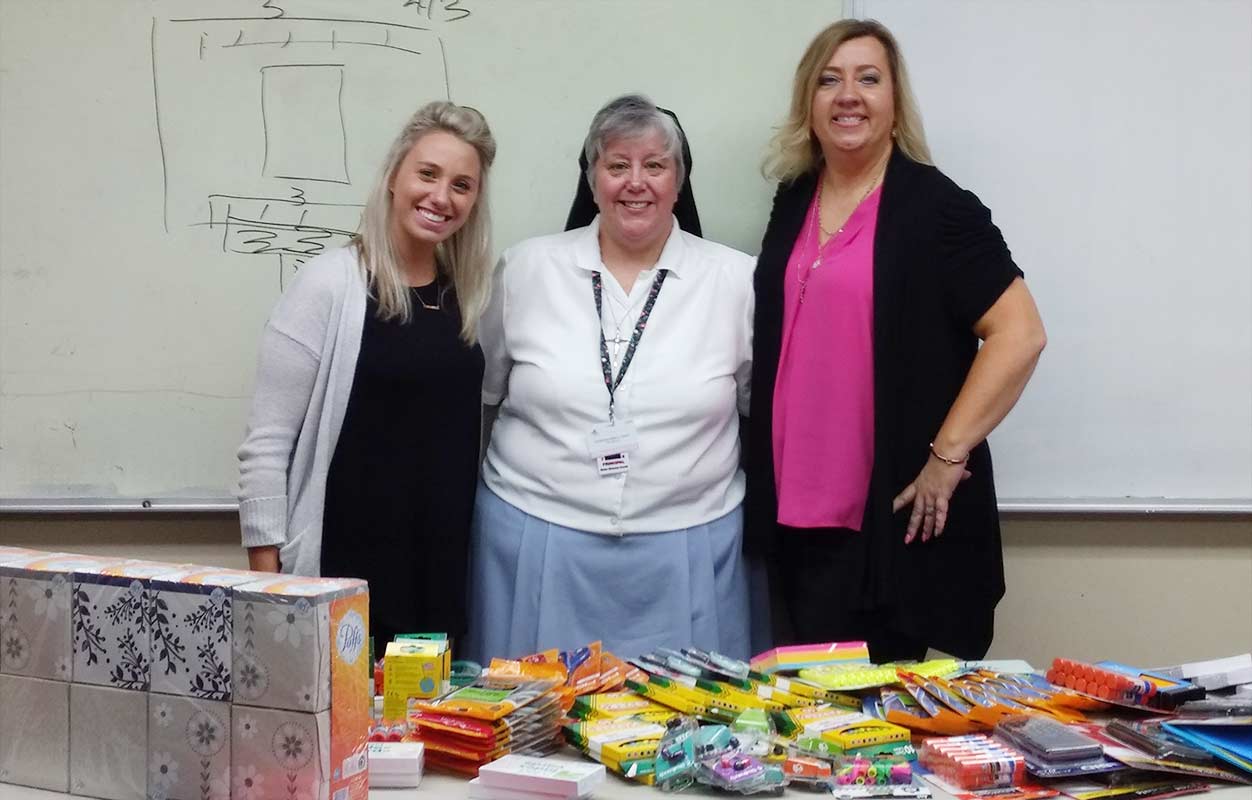 Kelly Morrione, Sister Maureen Donati and Jacqueline Kerris at a school-supply donation in 2018