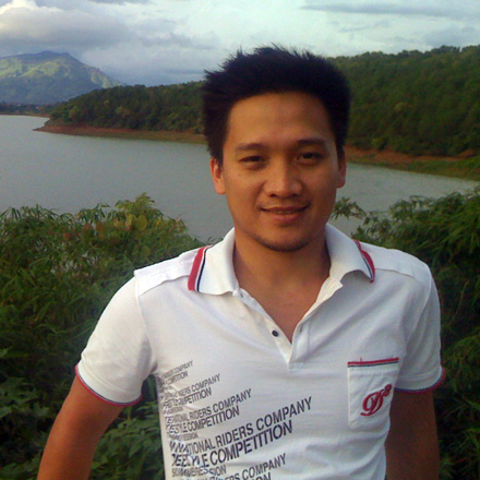 An earlier outdoor photograph of Duy Huynh beside a lake