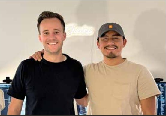 Dylan Allen and Ernesto Valencia standing together in a workspace