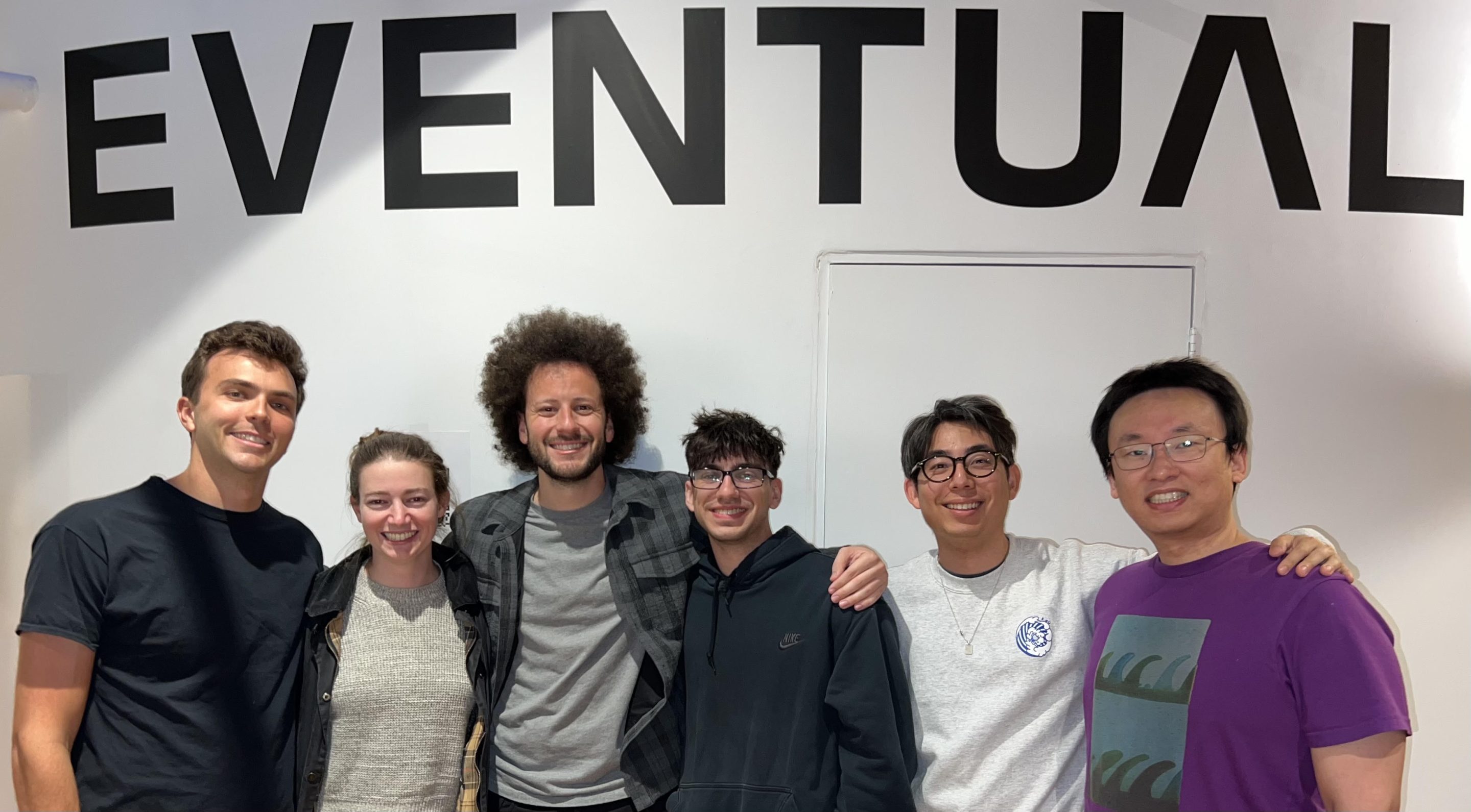 The Eventual team standing together in the company's office