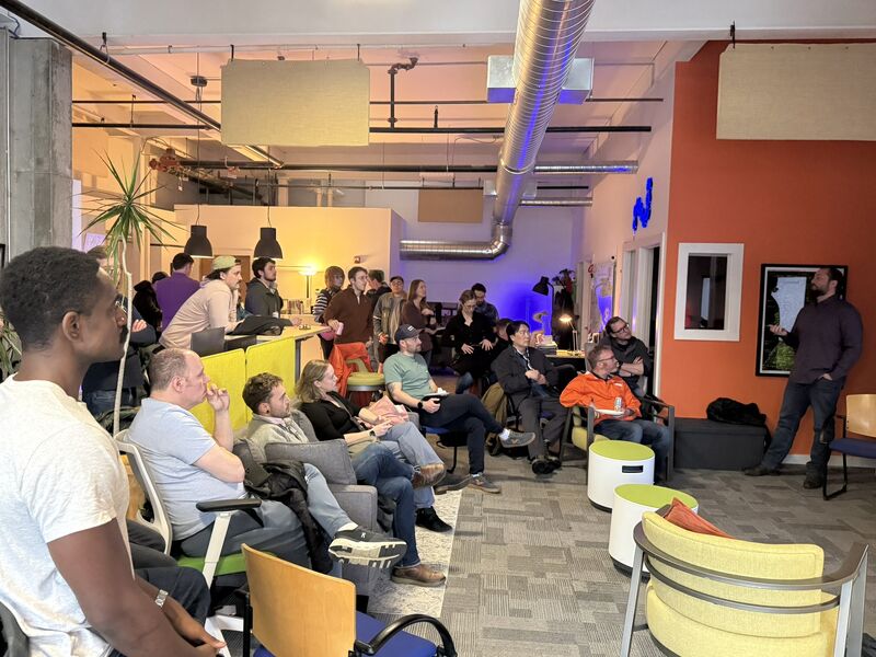Dylan Farnsworth presenting to an audience at a ChatBTV technology meetup in Burlington