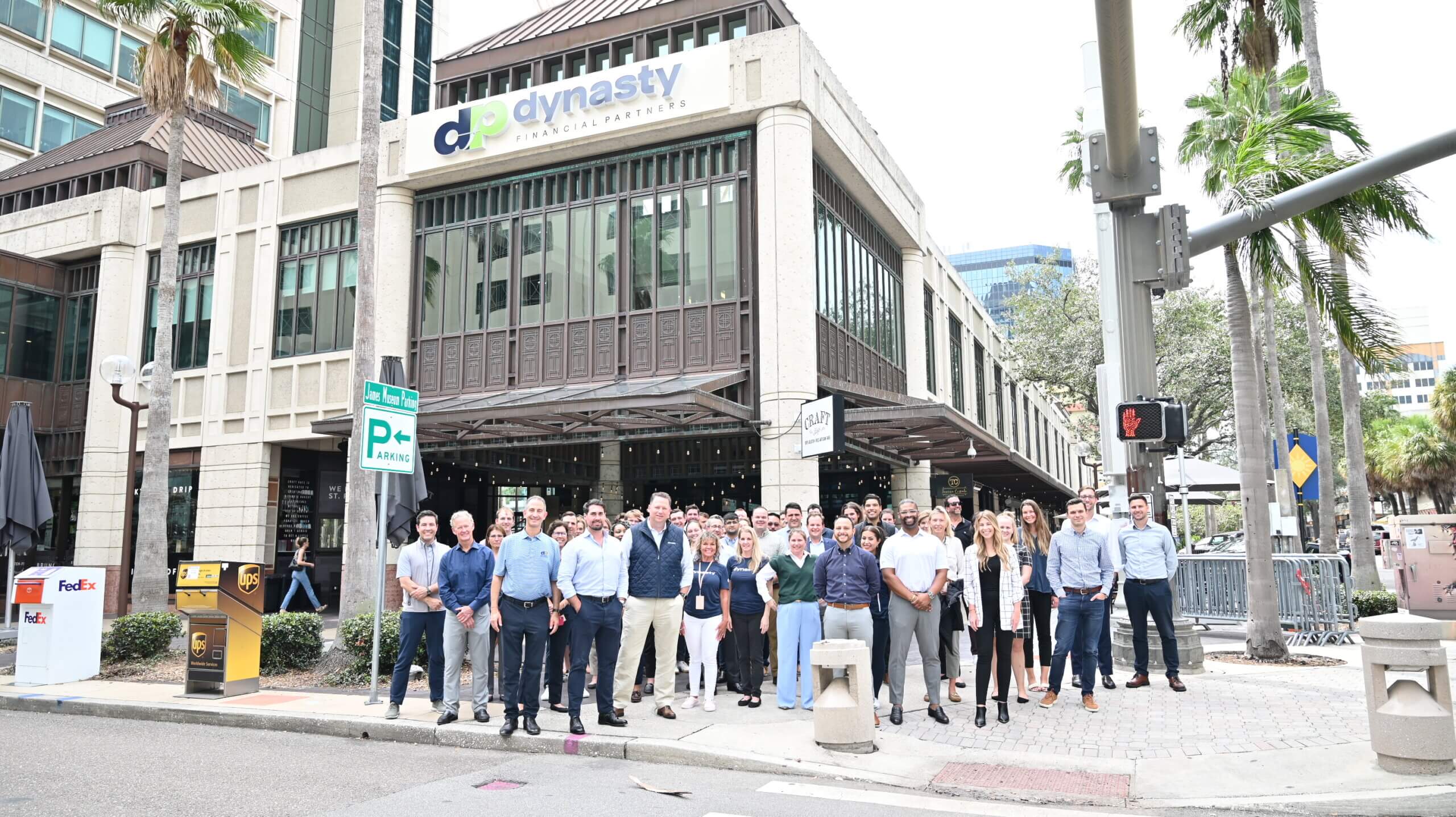 Dynasty team gathered outside its St. Petersburg office beneath palm trees