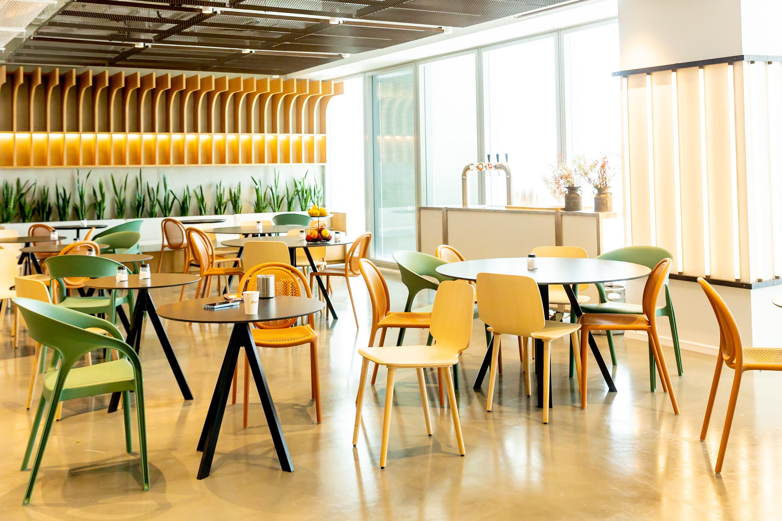 Sunlit communal space in Earnix’s Israel office, with green and yellow chairs