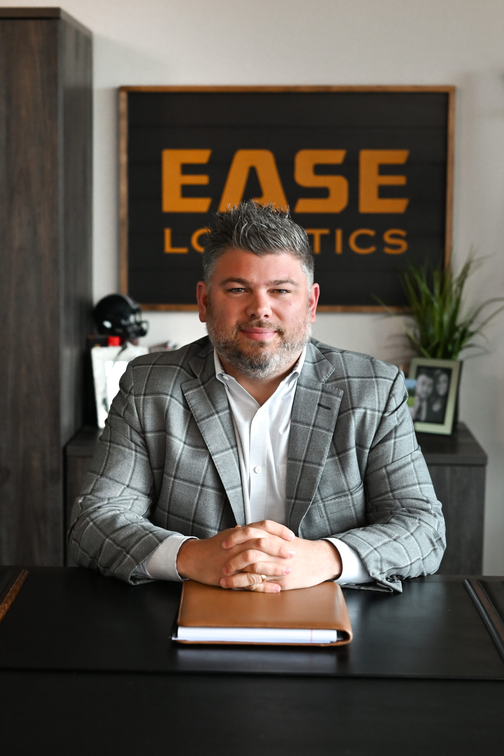 EASE founder Peter Coratola Jr. seated at a desk