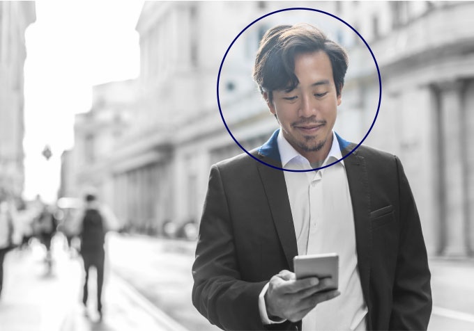 EASI marketing artwork showing a man using a phone on a city street, with a circle around his face