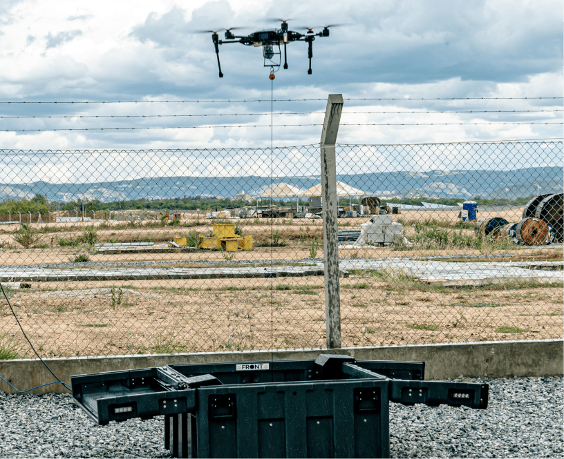 Easy Aerial tethered drone hovering above a fence with its open ground station below