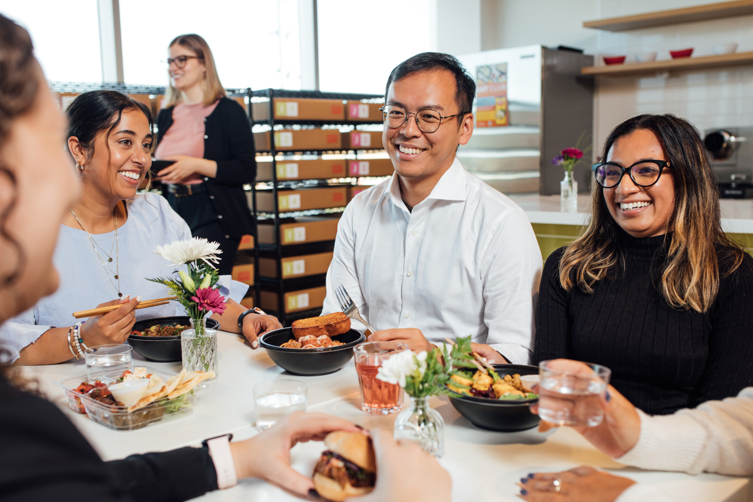 Coworkers share lunch around a table