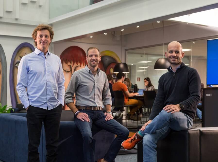 EBANX’s three co-founders pictured in an office