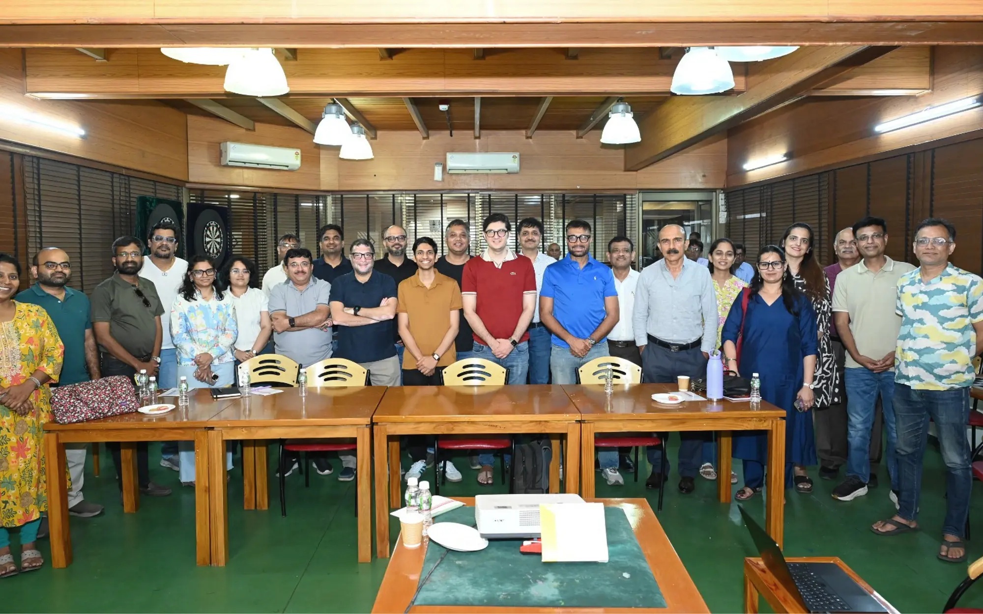 Participants gathered around tables at an eChai session at Karnavati Club in Ahmedabad