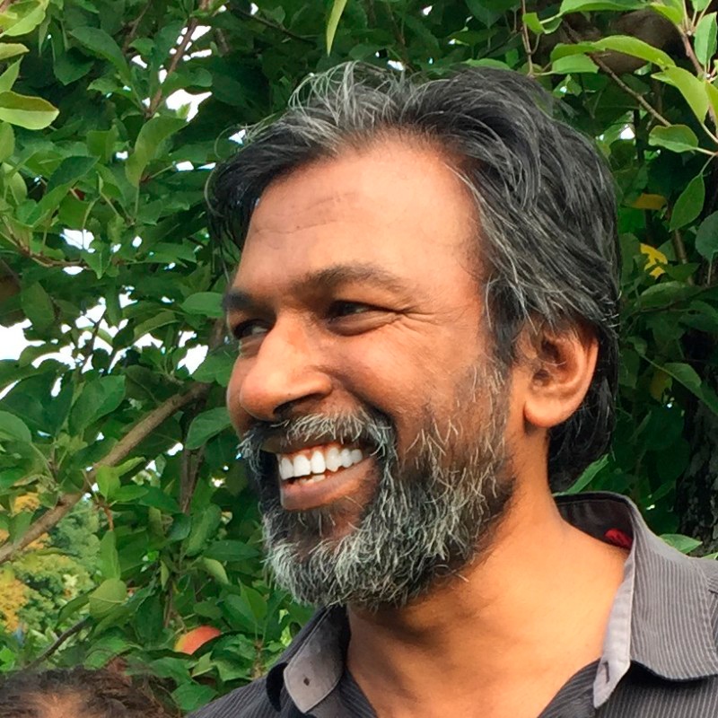 ECS Fin founder and CEO Jacob Aruldhas, smiling outdoors
