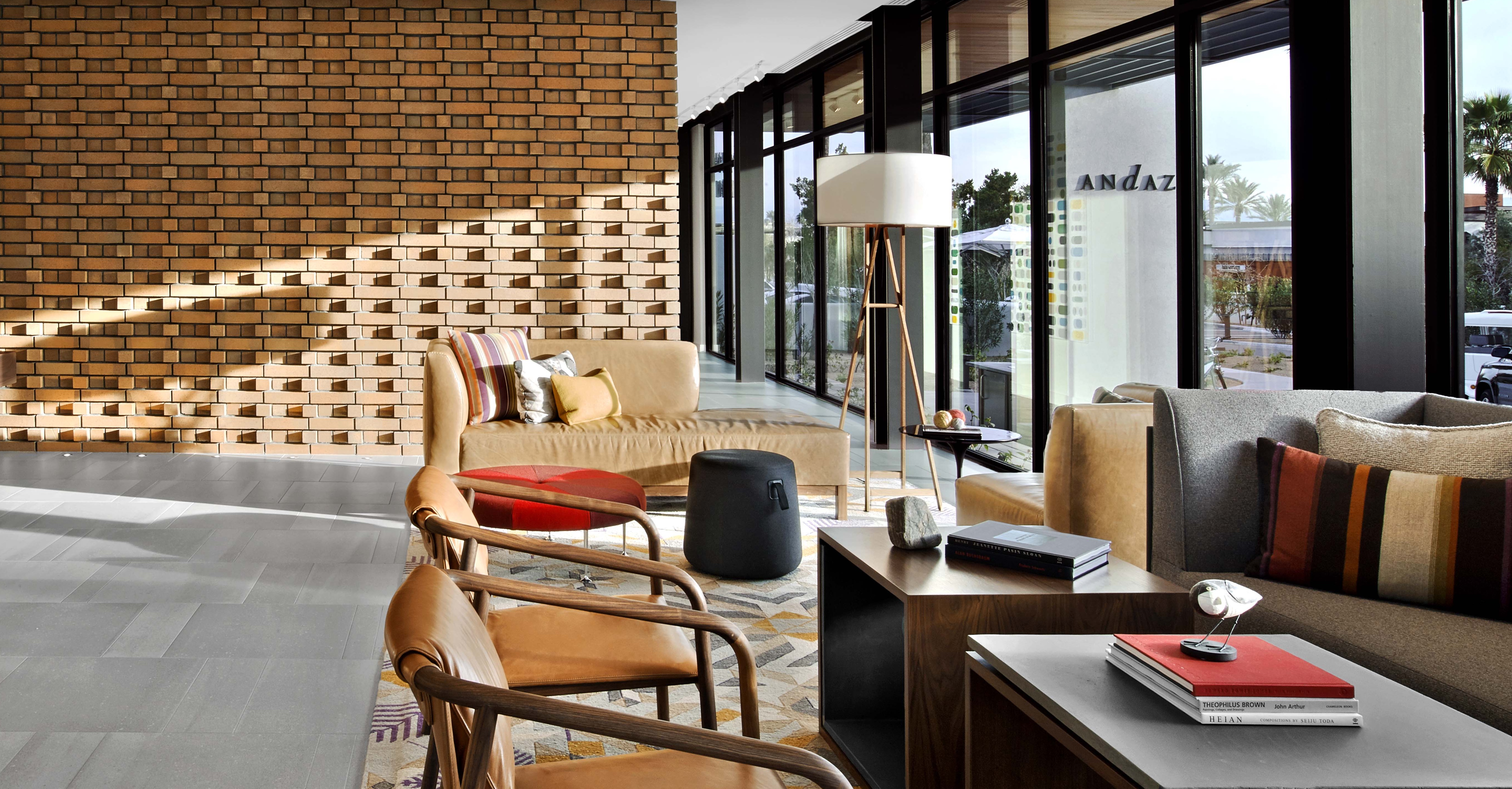Andaz Scottsdale lounge with patterned brickwork, leather chairs and large windows