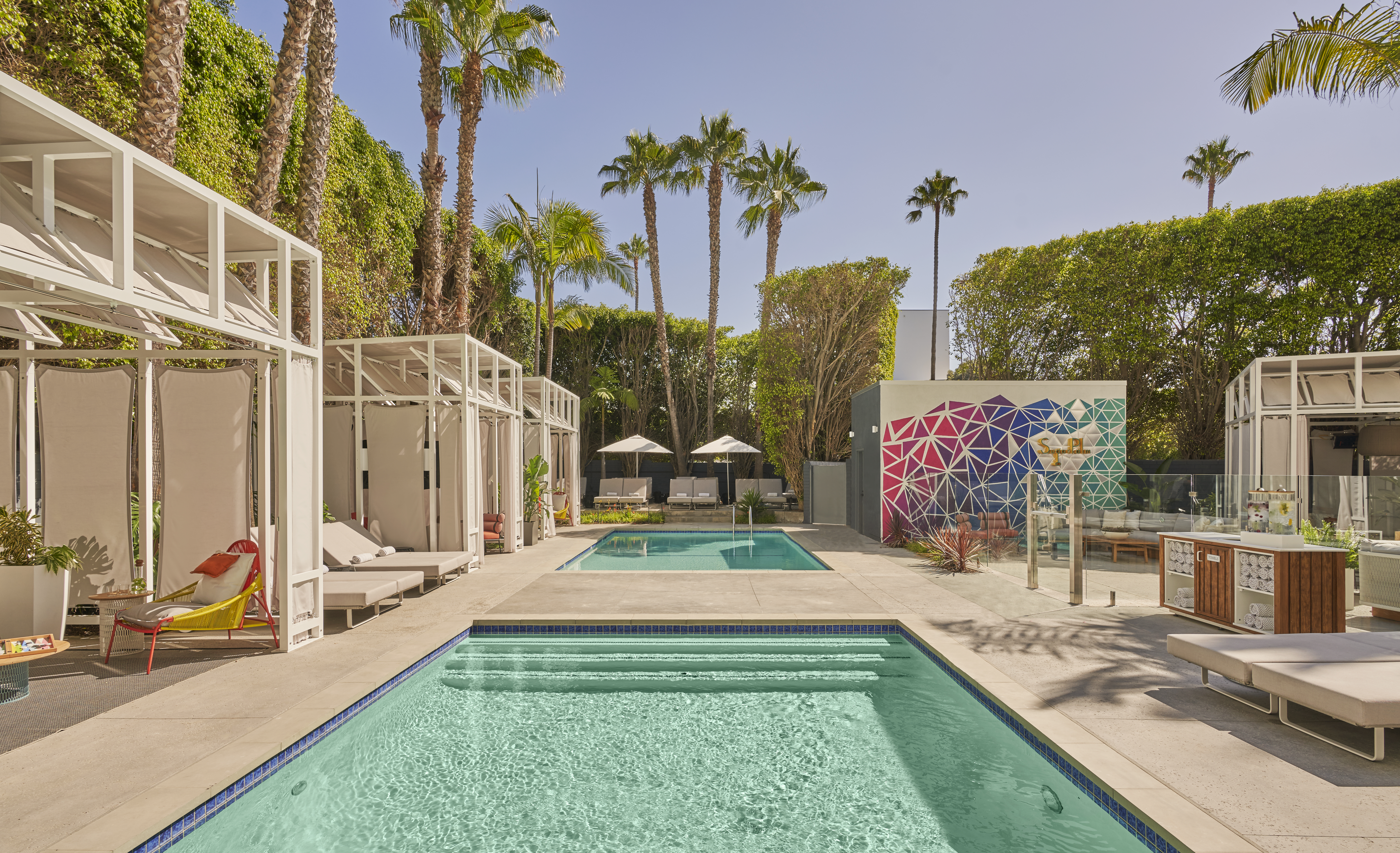Palm trees and open cabanas flank the pools at Viceroy Santa Monica