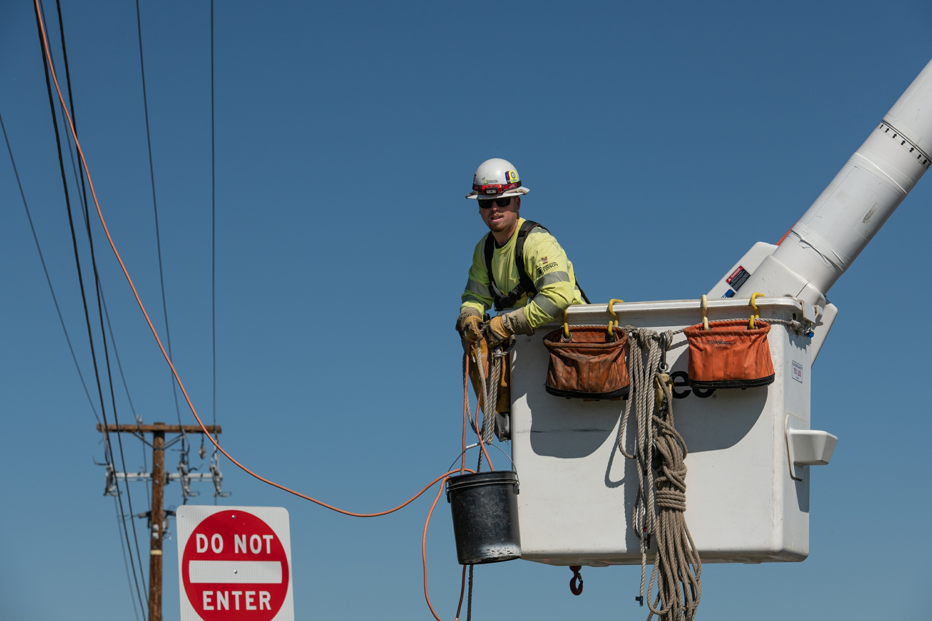 An SCE lineworker working from a bucket truck during a covered conductor installation