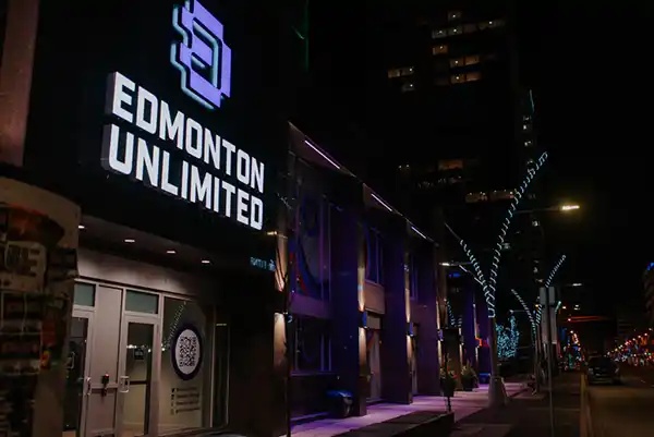Edmonton Unlimited’s illuminated entrance on Jasper Avenue at night