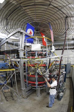 Graduate student Edward Hinson performing maintenance beside the Pegasus Toroidal Experiment at UW–Madison
