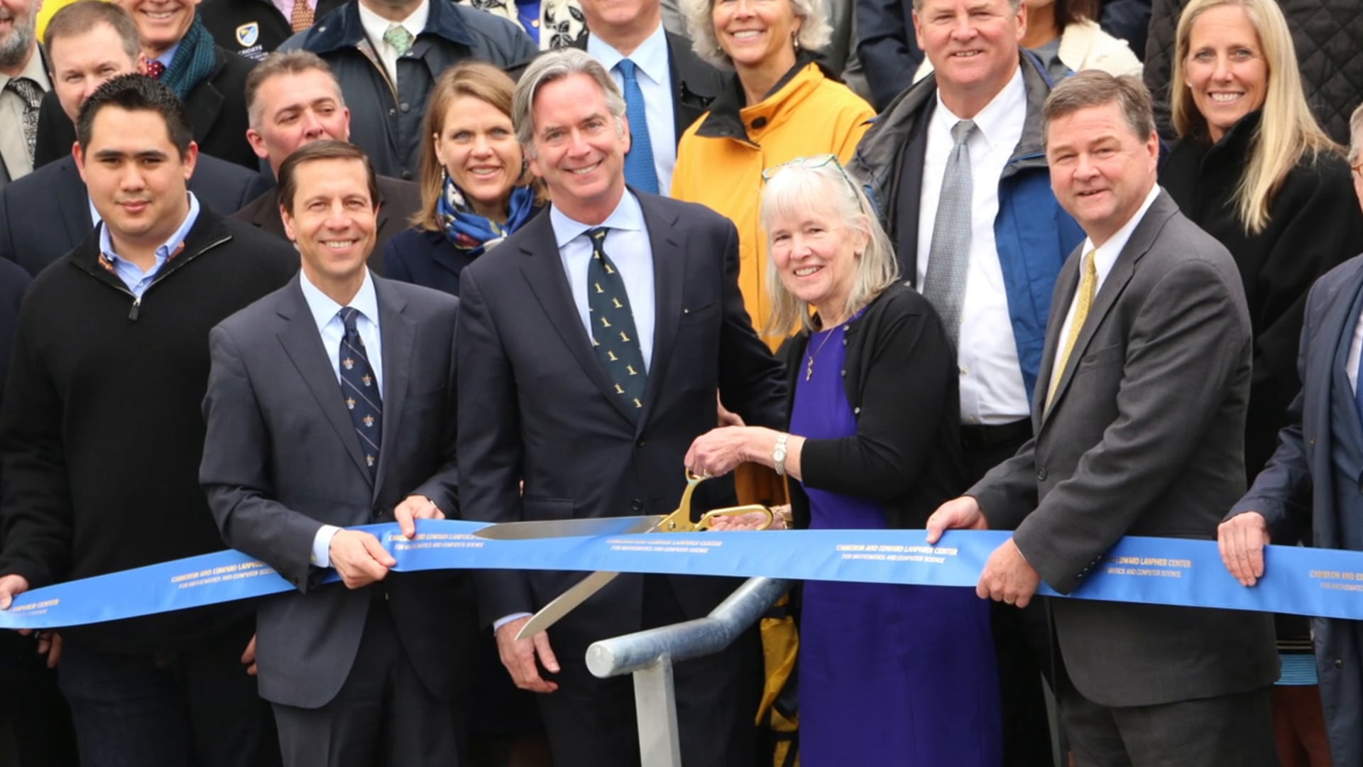 Cameron and Edward Lanphier join Choate’s ribbon cutting, Cameron holding scissors and Edward at the front right.