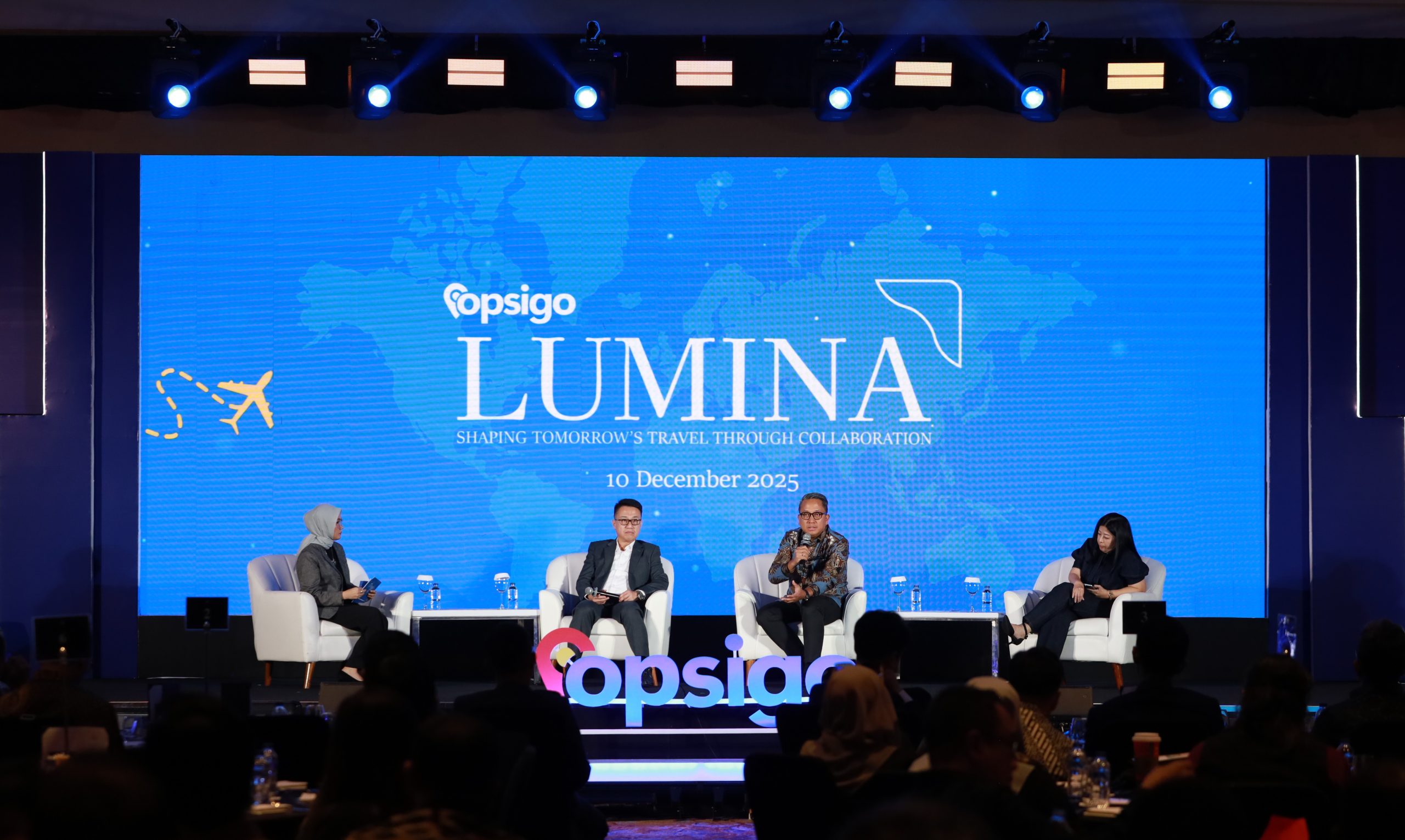 Four participants on stage during the travel digitalization discussion at Opsigo Lumina, Jakarta, December 10, 2025.