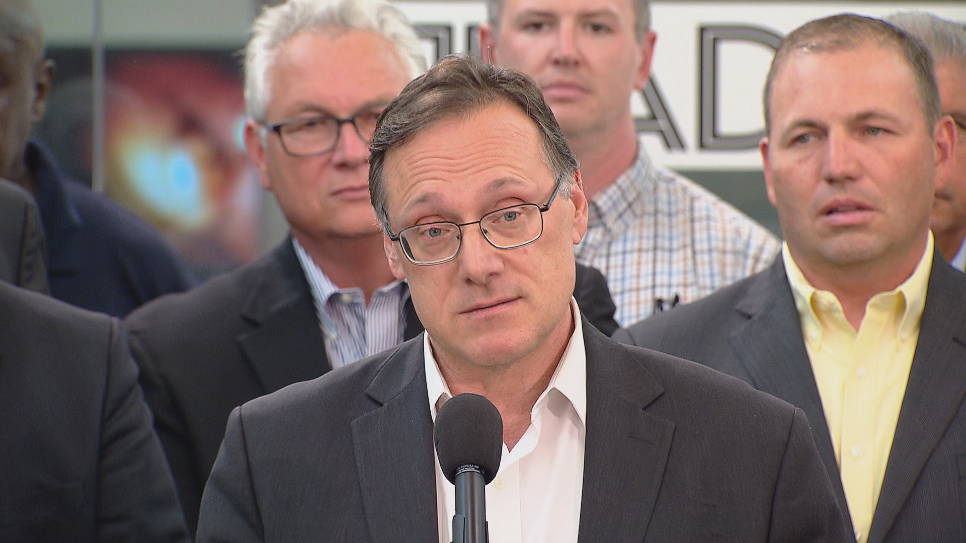 Edwin Eisendrath speaking at a podium as the new Chicago Sun-Times leadership is announced