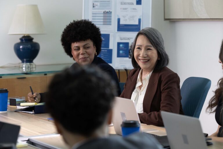 People smiling during a meeting for Medtronic's Missing Moments campaign