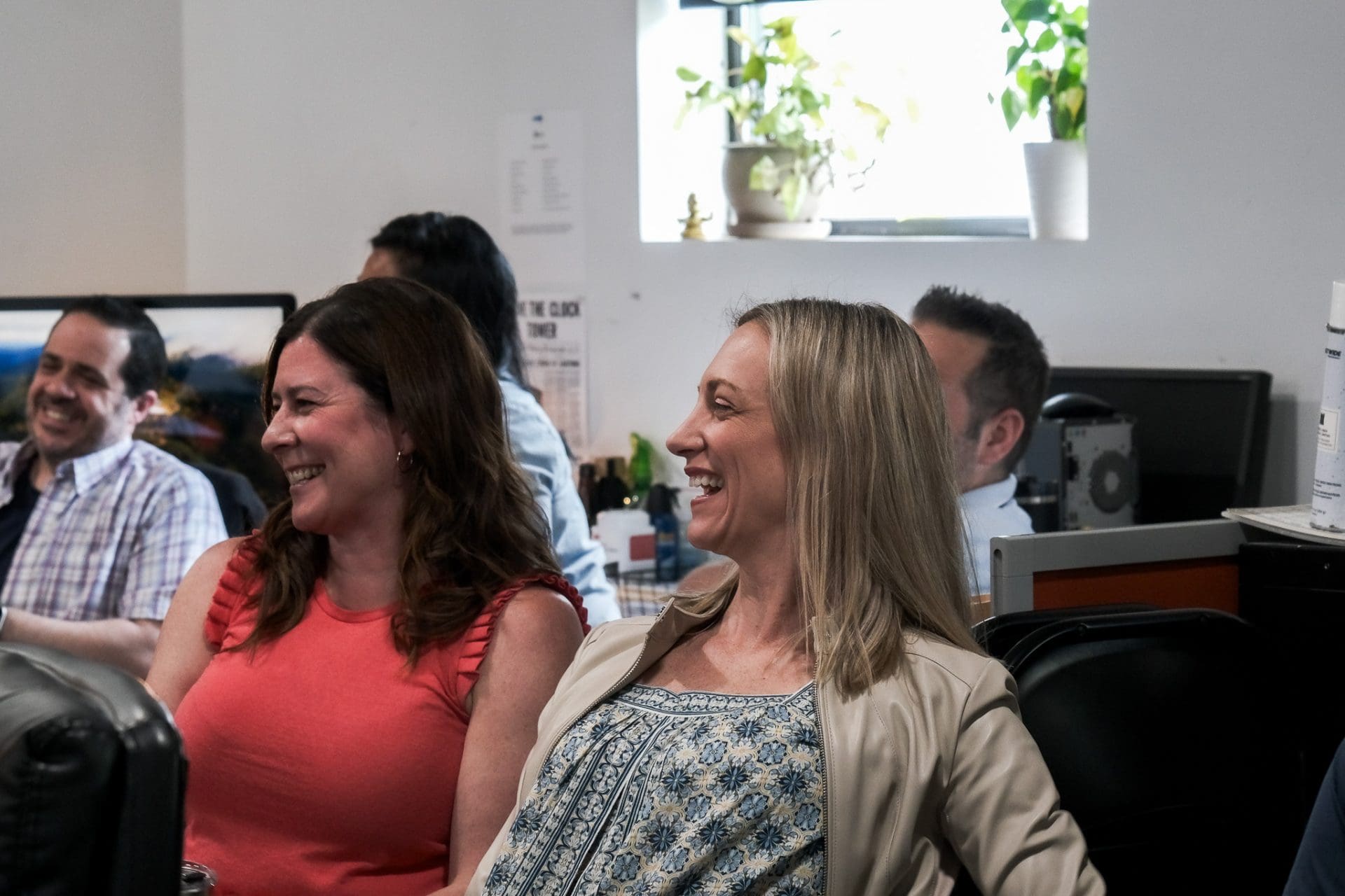 EGC Group colleagues laughing together during a meeting in the agency office
