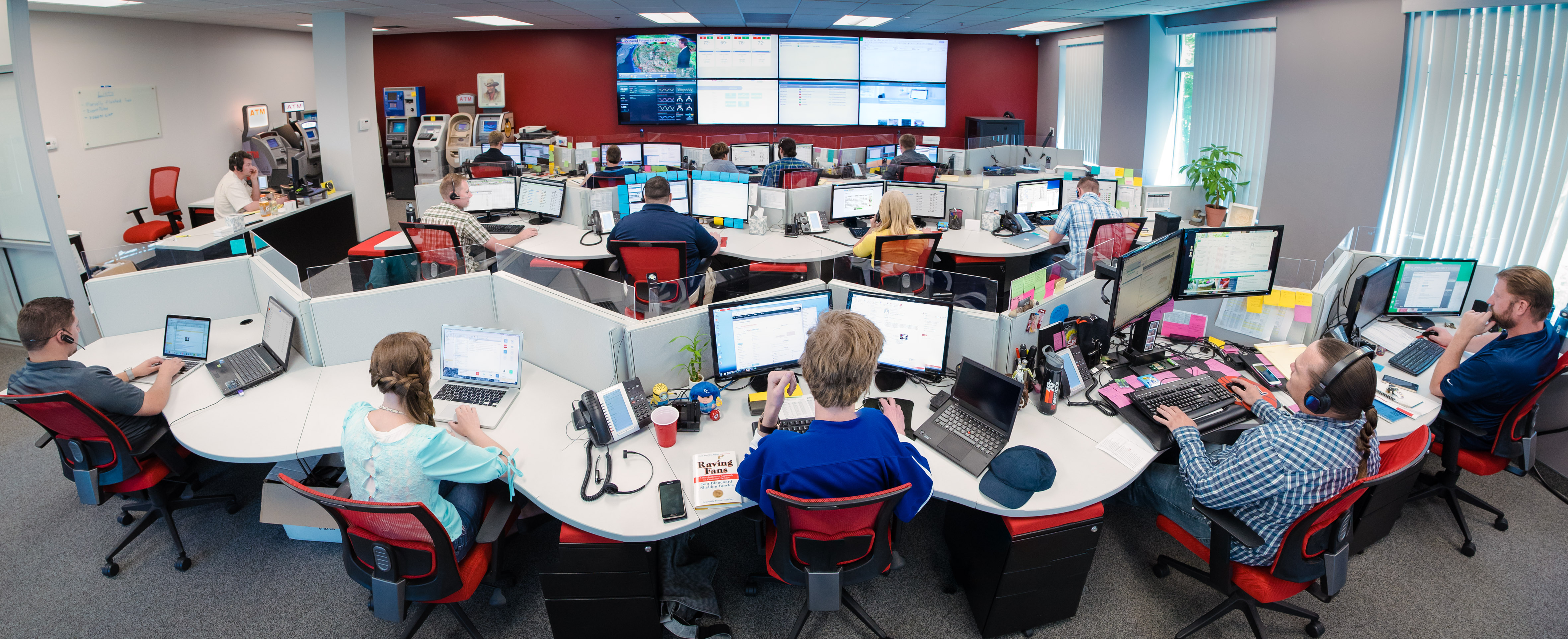 Grant Victor support staff working at computer stations in a shared operations room
