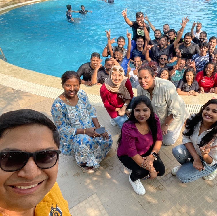 A group poses together beside a swimming pool in a photo on the company’s careers page