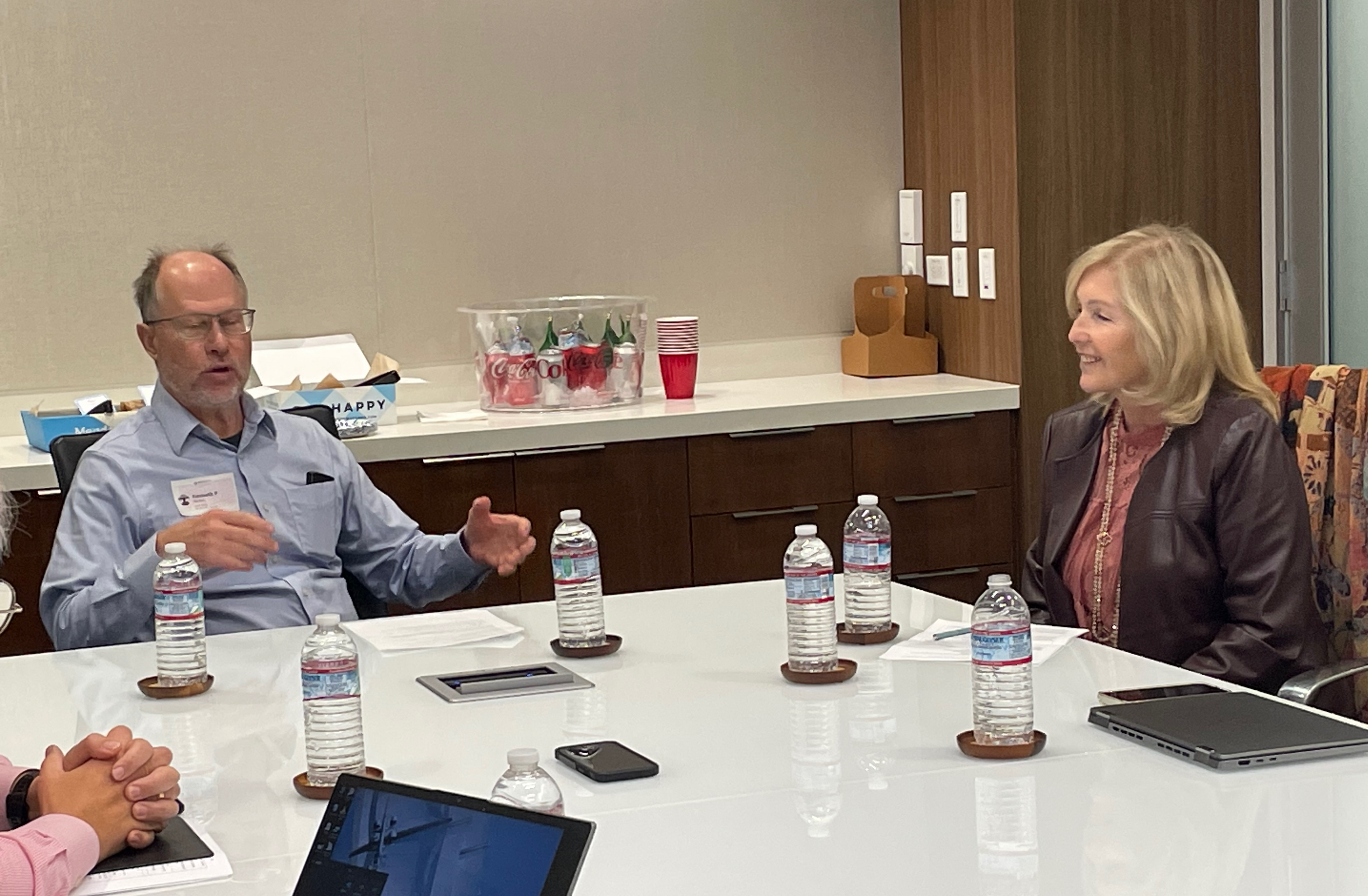 Eiry Roberts seated in conversation during a roundtable at Neurocrine's San Diego headquarters