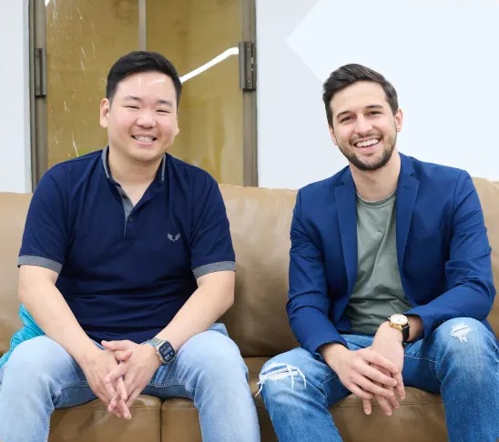 RentSpree co-founders Ekabutr Sirisuphang and Michael Lucarelli seated together on a sofa