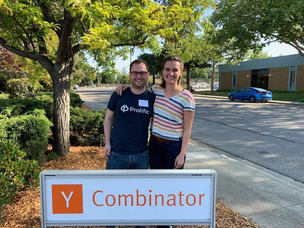 Phelim Bradley and Ekaterina Damer standing beside a Y Combinator sign in California