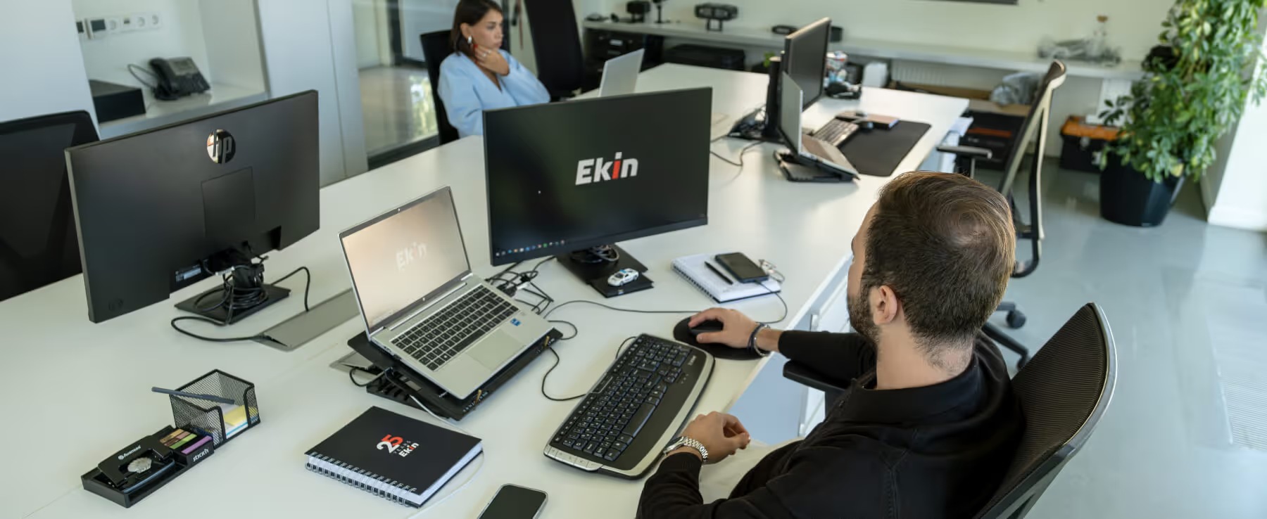 Ekin employees working with computers in an office