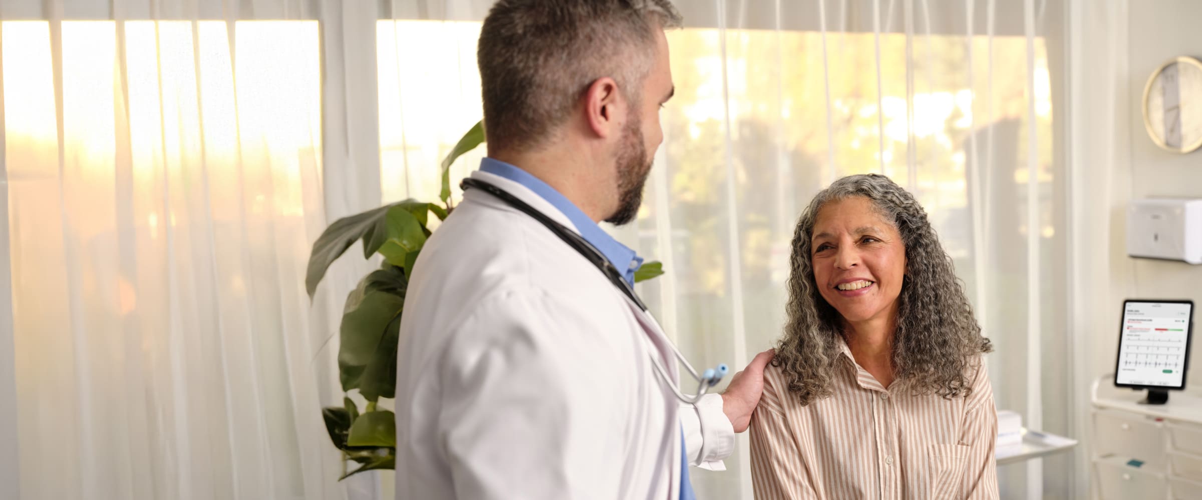 A clinician uses a stethoscope during a patient examination