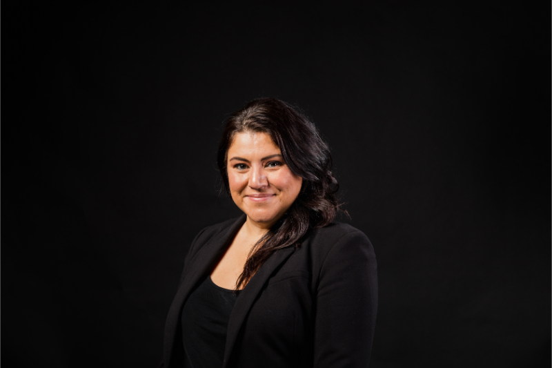 Elaine Dimakos in an official PPCR portrait against a dark background