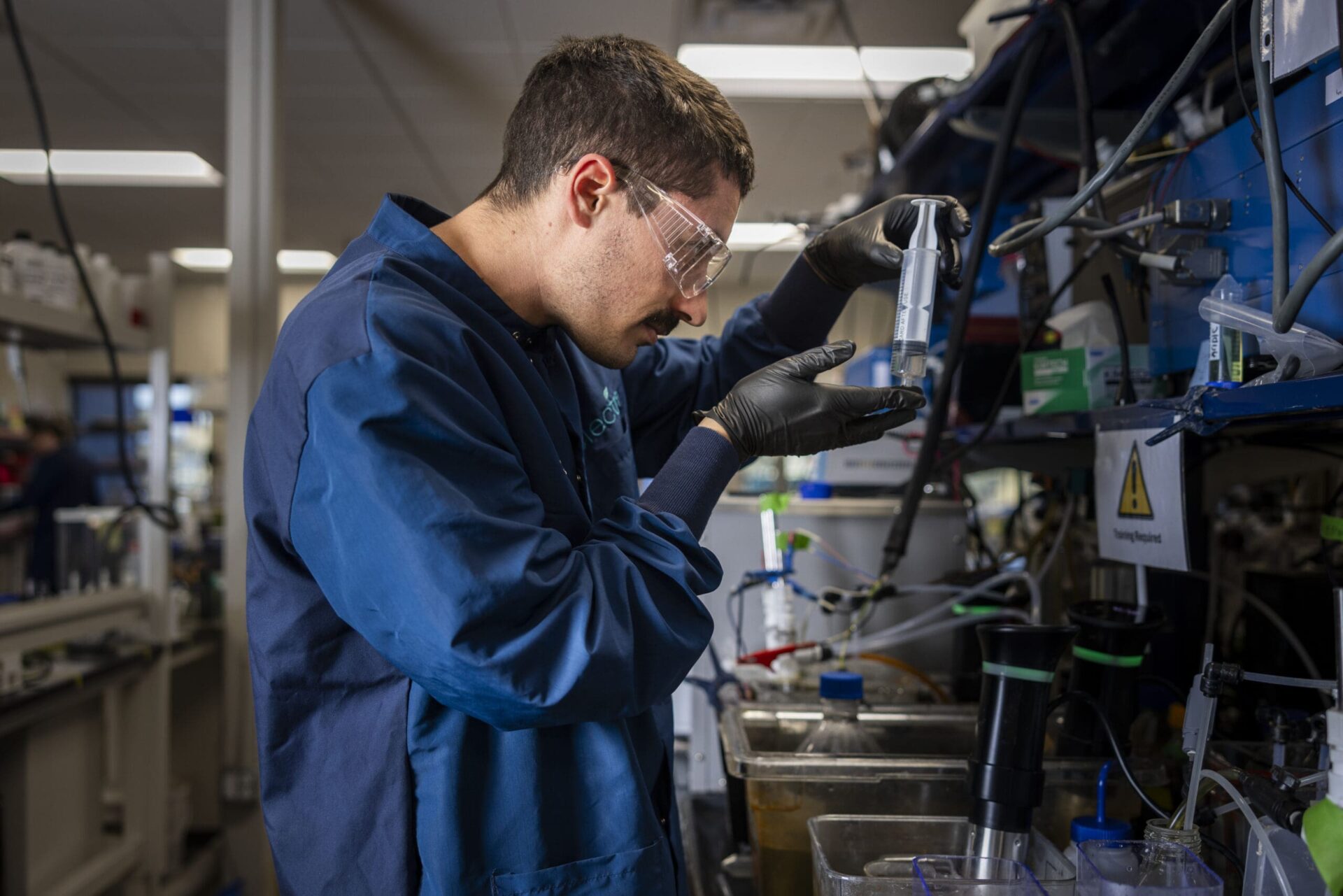 An Electra technician working with laboratory equipment in Boulder