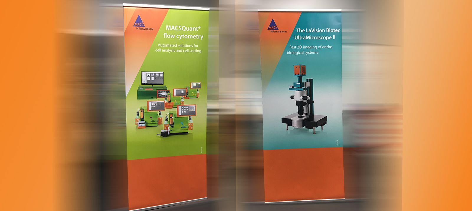 Two colorful retractable trade-show banners featuring laboratory instruments, pictured on EPS’s website