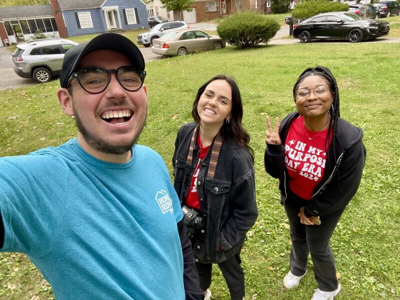 Purpose Day participants smiling outside during a Home Repairs for Good volunteer project in 2024