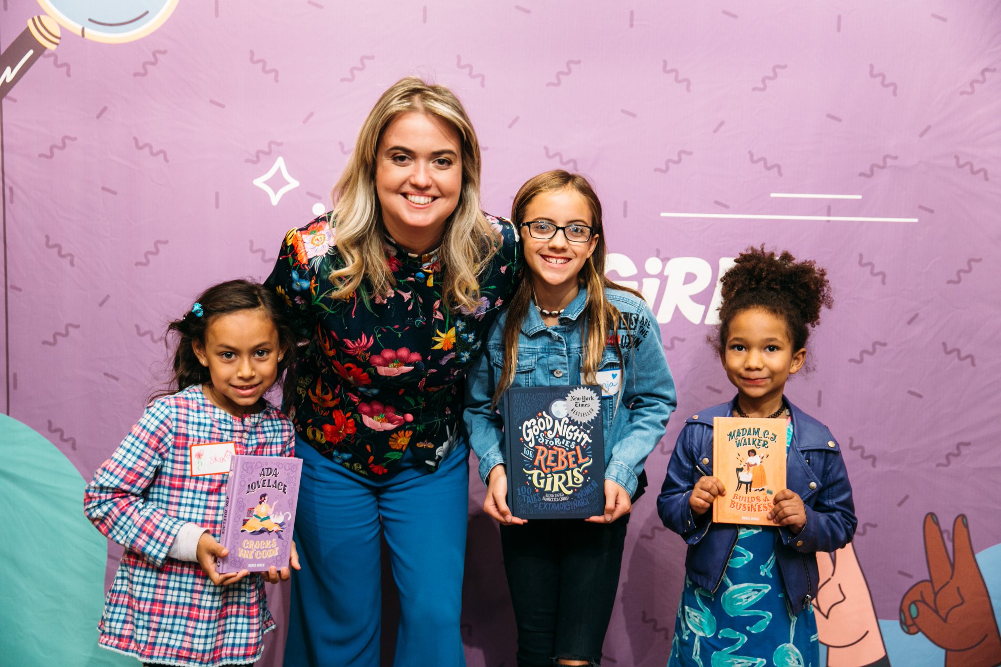 Elena Favilli with three young readers holding Rebel Girls books at The Wing in New York
