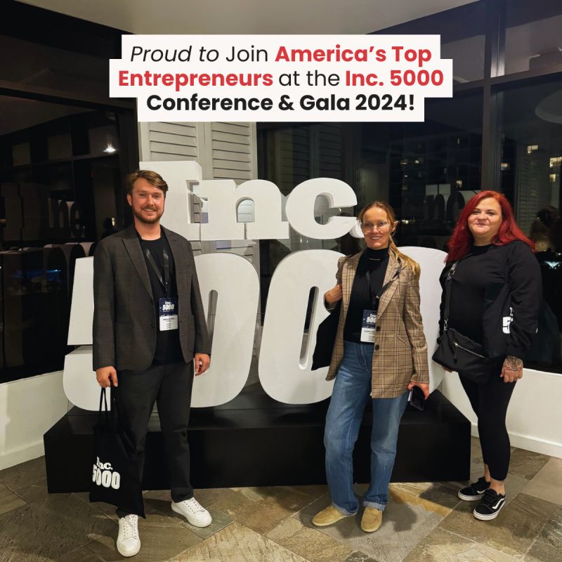 Ad Astra representatives posing beside Inc. 5000 signage at the 2024 conference