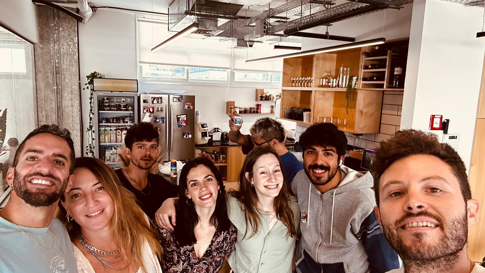 Members of Eleos's Tel Aviv team gathered in an office kitchen