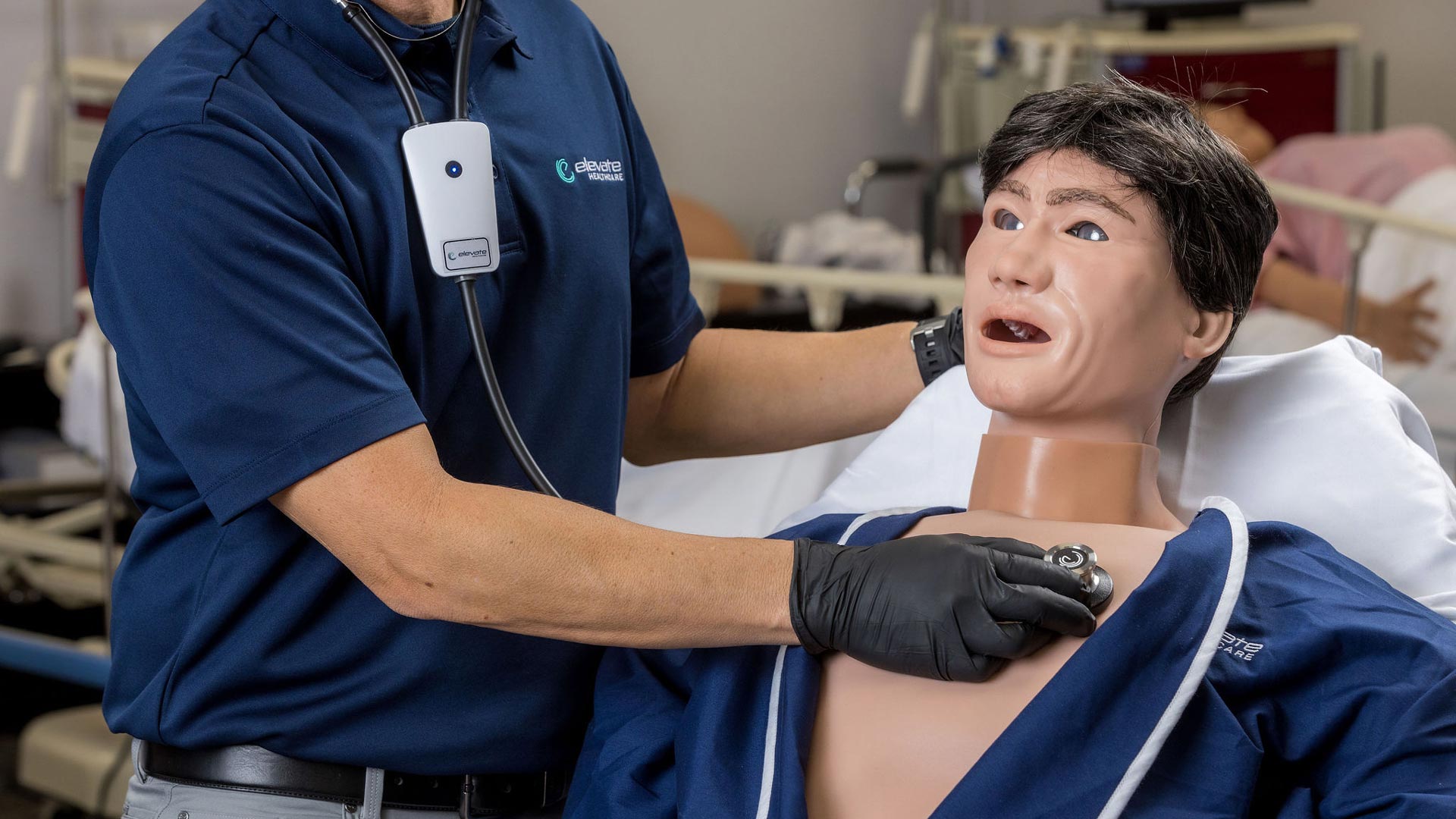 A demonstrator uses a stethoscope on an Evo patient simulator