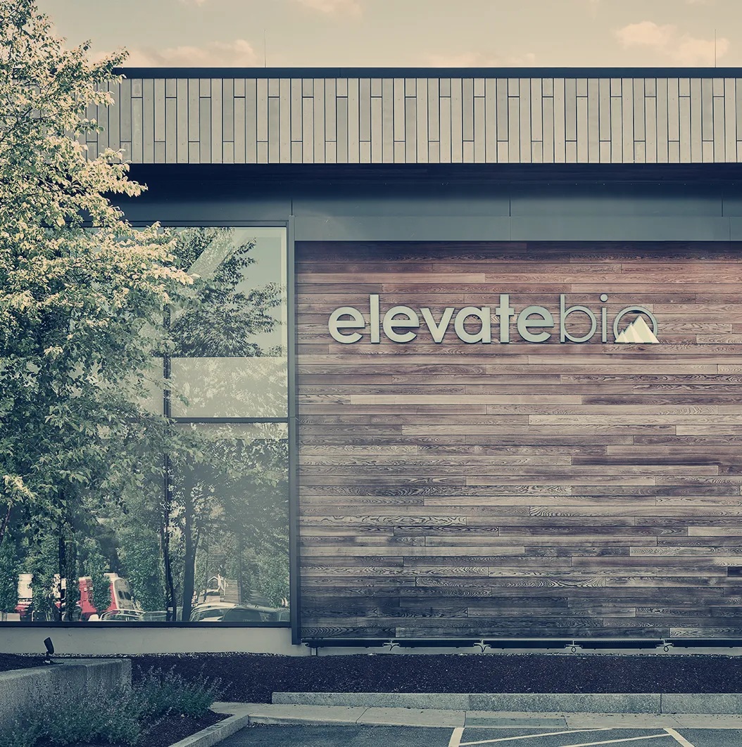 Exterior of ElevateBio’s BaseCamp Waltham facility, with wood cladding and large windows